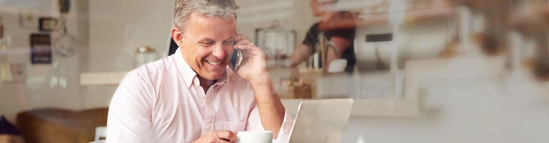 busy-professionals man talking on phone while looking at computer