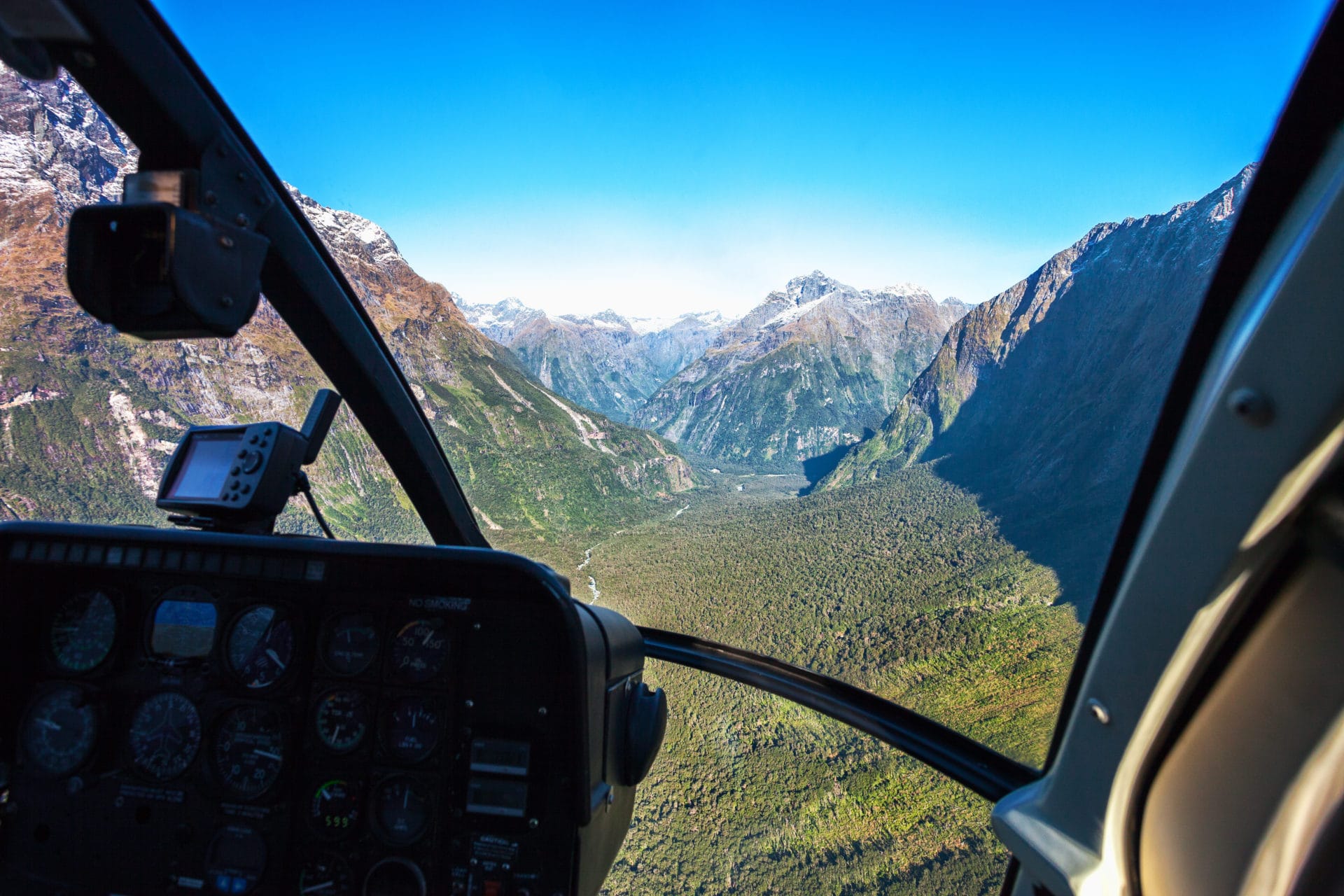 Scenic helicopter flight with view from cockpit, Milford Sound , Fiordland National Park, South Island, New Zealand.