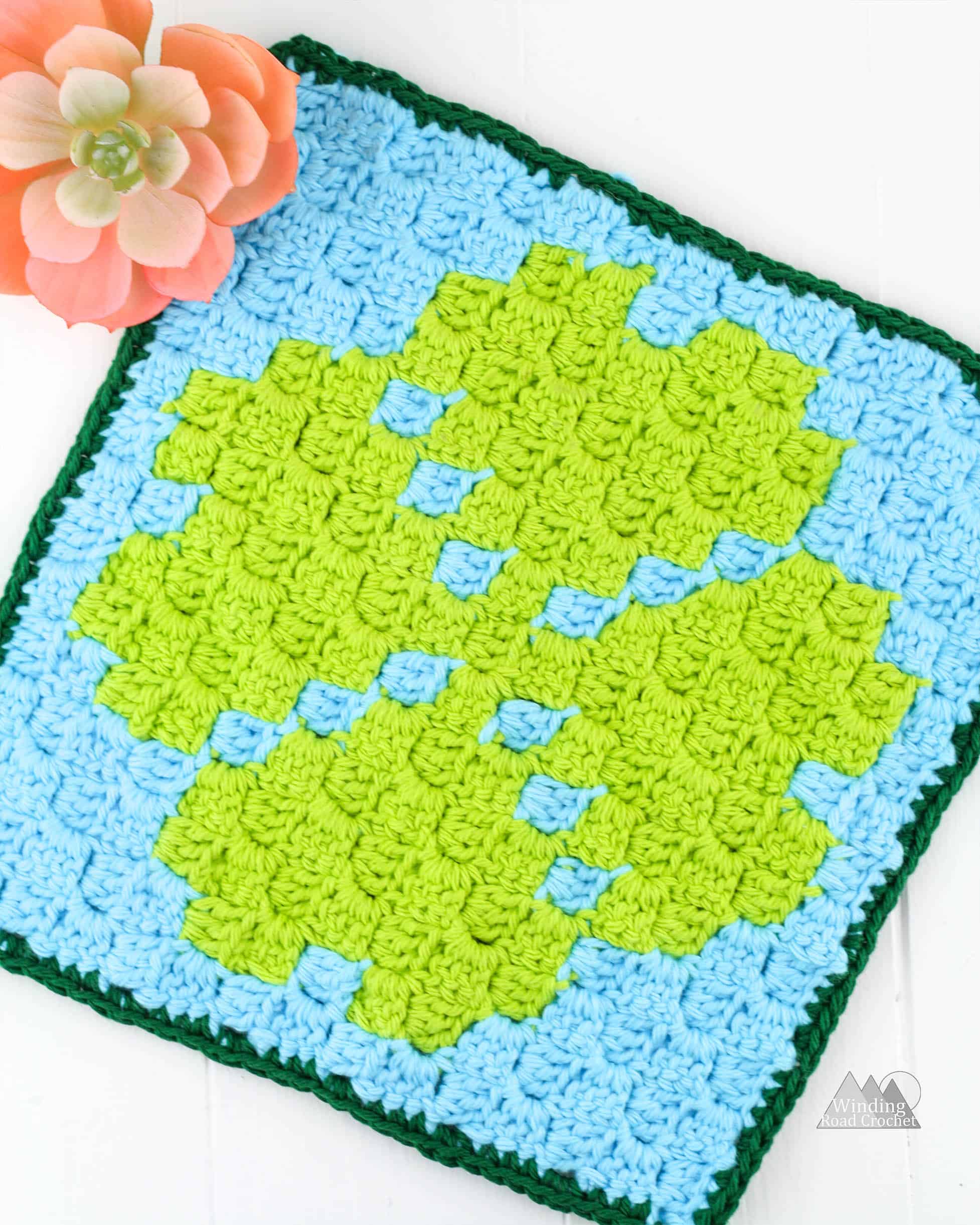 Crochet a quick Corner to corner crochet wash cloth or pot holder using this small Four Leaf Clover C2C graph. This graph works up quickly and is designed to c2c beginners. Get the graph, written chart and suggestions for using yarn bobbins. #c2ccrochet #crochetwashcloth #crochetpotholder