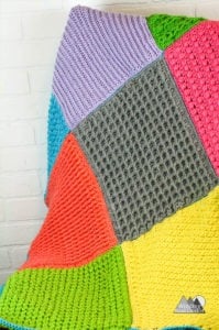 Use this collection of crochet stitch tutorials to make this crochet sensory baby blanket. This blanket makes a great gift and is so fun to create with all the beautiful textured crochet stitch squares. #crochetblanket #crochetbabyblanket