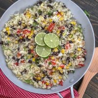 Cilantro Lime Black Bean and Corn Cauliflower Rice - an incredibly easy and flavorful side dish that is packed full of veggies and can be on your plate in 15 minutes or less! 115 calories per serving! #healthy #cauliflowerrice #glutenfree #vegan #healthy | https://withpeanutbutterontop.com