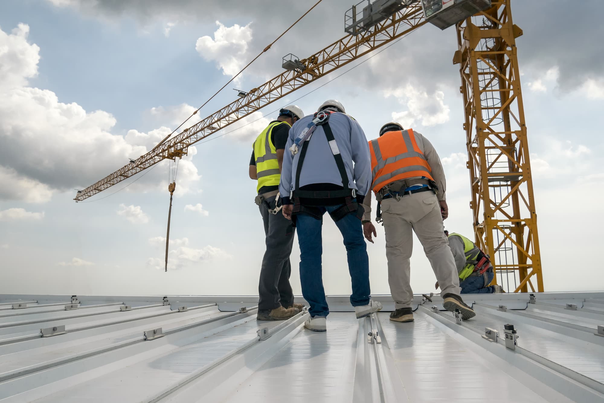 Construction engineer wear safety uniform inspection metal roofi Construction engineer wear safety uniform inspection metal roofing work for roof industrial concept with copy space