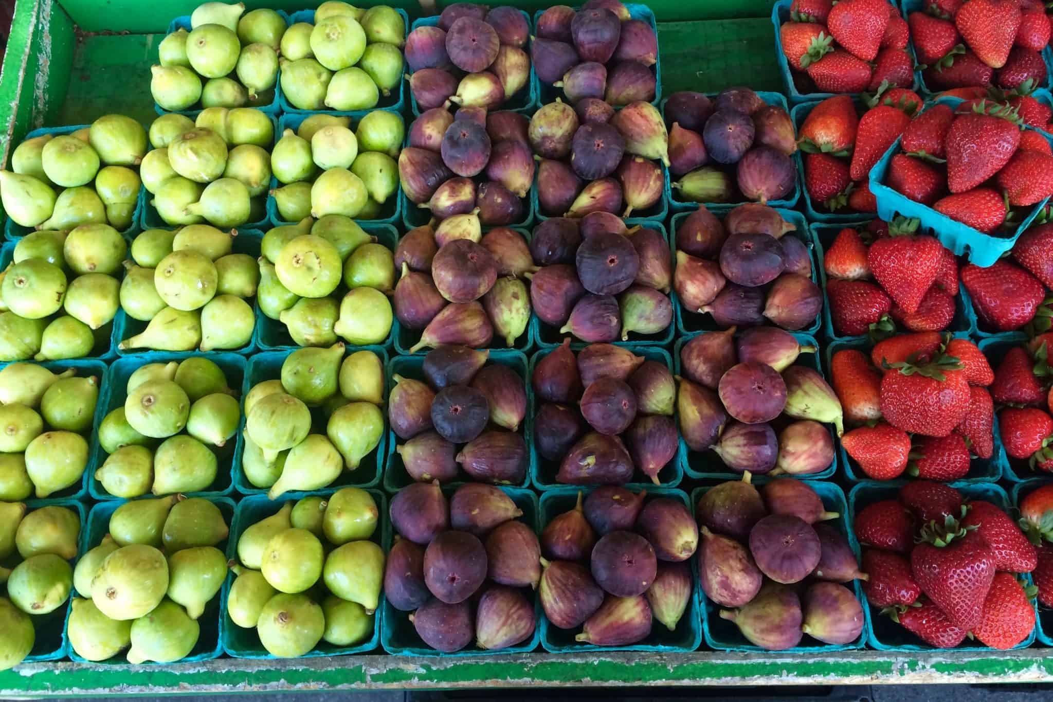 Small baskets of figs and strawberries for sale