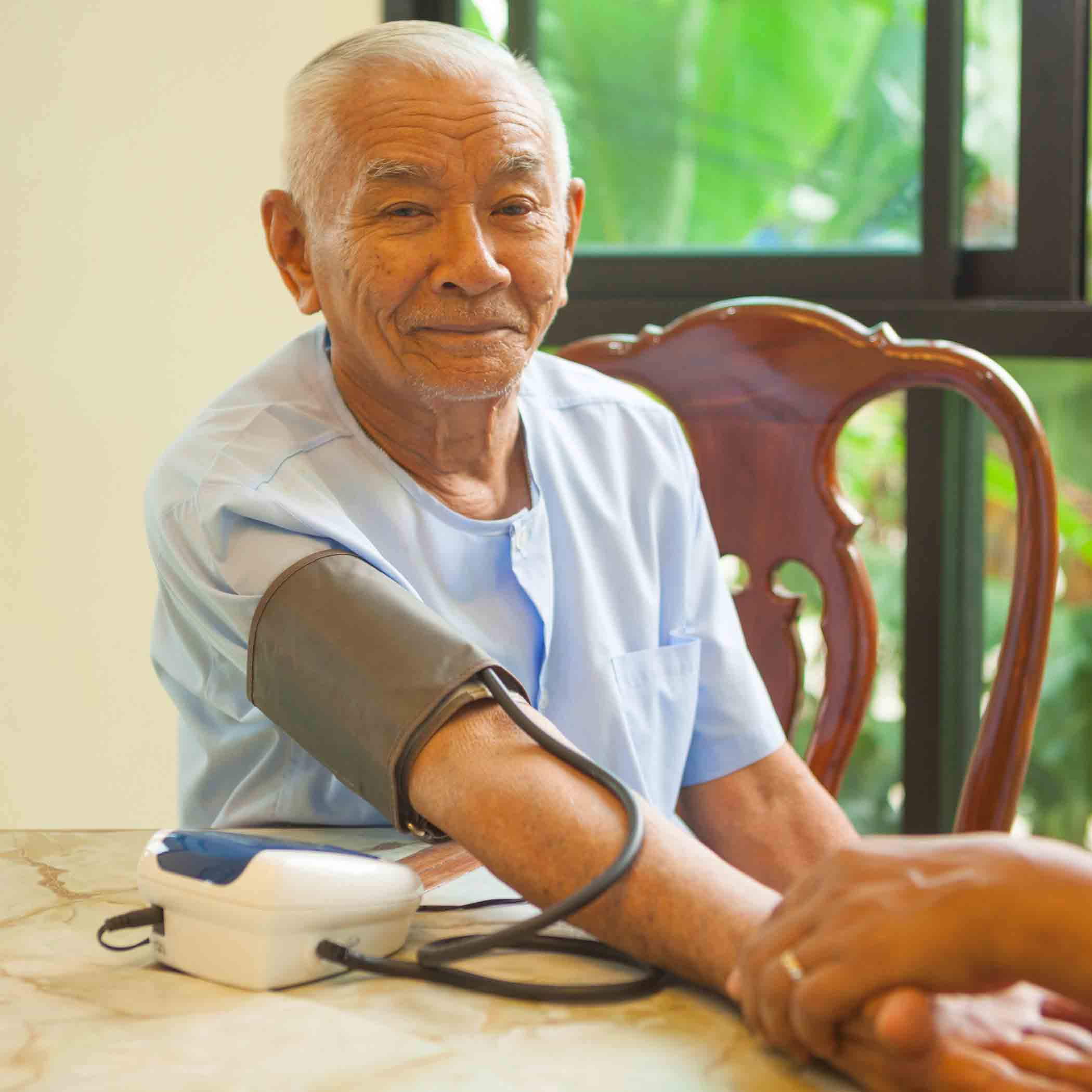 measuring blood pressure of male patient