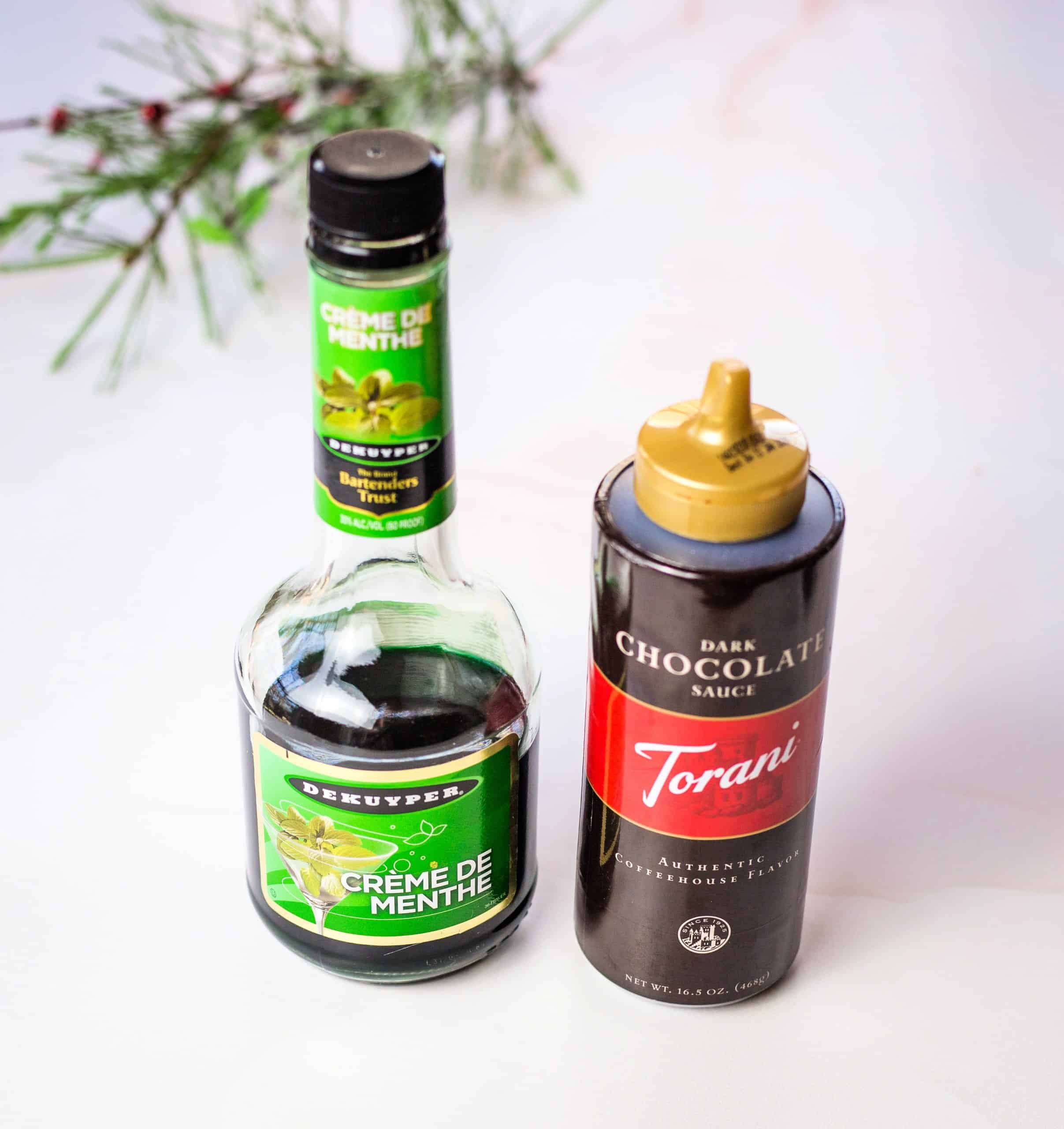 a bottle of creme de menthe and torani dark chocolate sauce