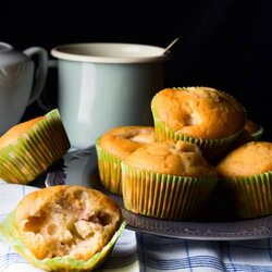 Peach and mango muffins on gray plate with greenery