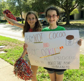 Rachel Newman (right) and her friend Felicia Gal (left) sold treats to raise money for Habitat Collier. Courtesy: Leigh Ann Newman