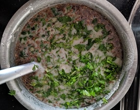finely chopped coriander leaves and green chillies in kambu dosai batter