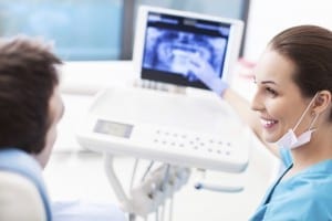 Dentist explaining x ray picture to patient