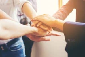 hands-joined-by-the-team_1150-100 hands-joined-by-the-team_1150-100