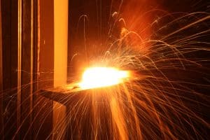 Antique Single Sided Spot Welder - photo of a blacksmith hammering hot metal together