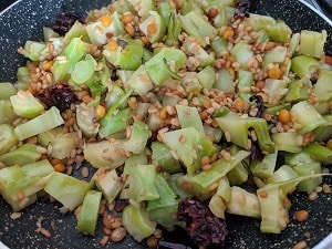 Adding water to the chutney mix to soften the stem