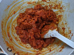 Cook the onion tomato mix until the raw smell goes