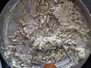 Mashing the cooked raw banana and sweet potato