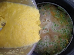 adding the sweet corn puree to thicken the soup