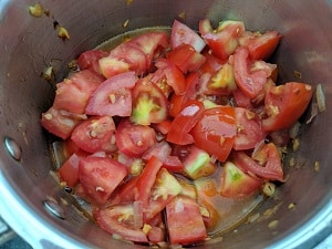 Chopped tomatoes added to the onion garlic mix