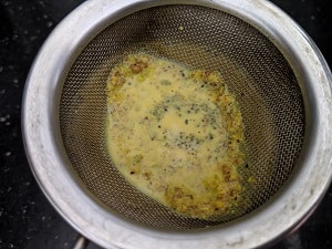 Straining the turmeric milk before serving
