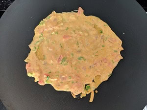 cooking the omelette on hot tava