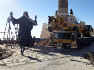This Oct. 14, 2013 photo provided by the St. Paul's and St. George's Foundation shows workers preparing to install a statue of Jesus on Mount Sednaya, Syria. In the midst of a civil war rife with sectarianism, a 12.3-meter (40-foot) tall, bronze statue of Jesus has gone up on a Syrian mountain, apparently under cover of a truce among three factions - Syrian forces, rebels and gunmen in the Christian town of Sednaya. (Photo: Samir El-Gadban, AP)