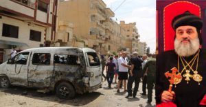 People and security forces belonging to the Sotoro, a Christian militia based in Syria's northeast, gather at the site of a suicide bomb attack carried out on Sunday in the divided Syrian city of Qamishli. A file photo of Patriarch Ignatius Aphrem II is seen on the right. AFP/Onmanorama