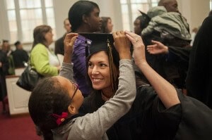 Christina Hamlin, looks to her husband Damian as her daughter Melia adjusts her mortarboard.