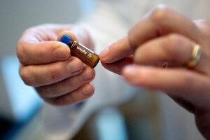 Dr. Barr shows a vial that is used with one of the Gas Chromatography Mass Spectrometers at Emory.