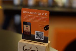 Digitale Stempelkarte: Aufsteller mit QR-Code als Bonuskarte