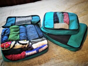 Packing cubes filled with clothes for RTW family travel
