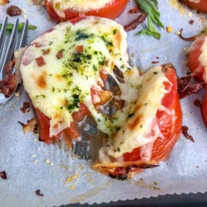 Easy sheet pan appetizer for tomato slices baked with mozzarella and parmesan cheeses.