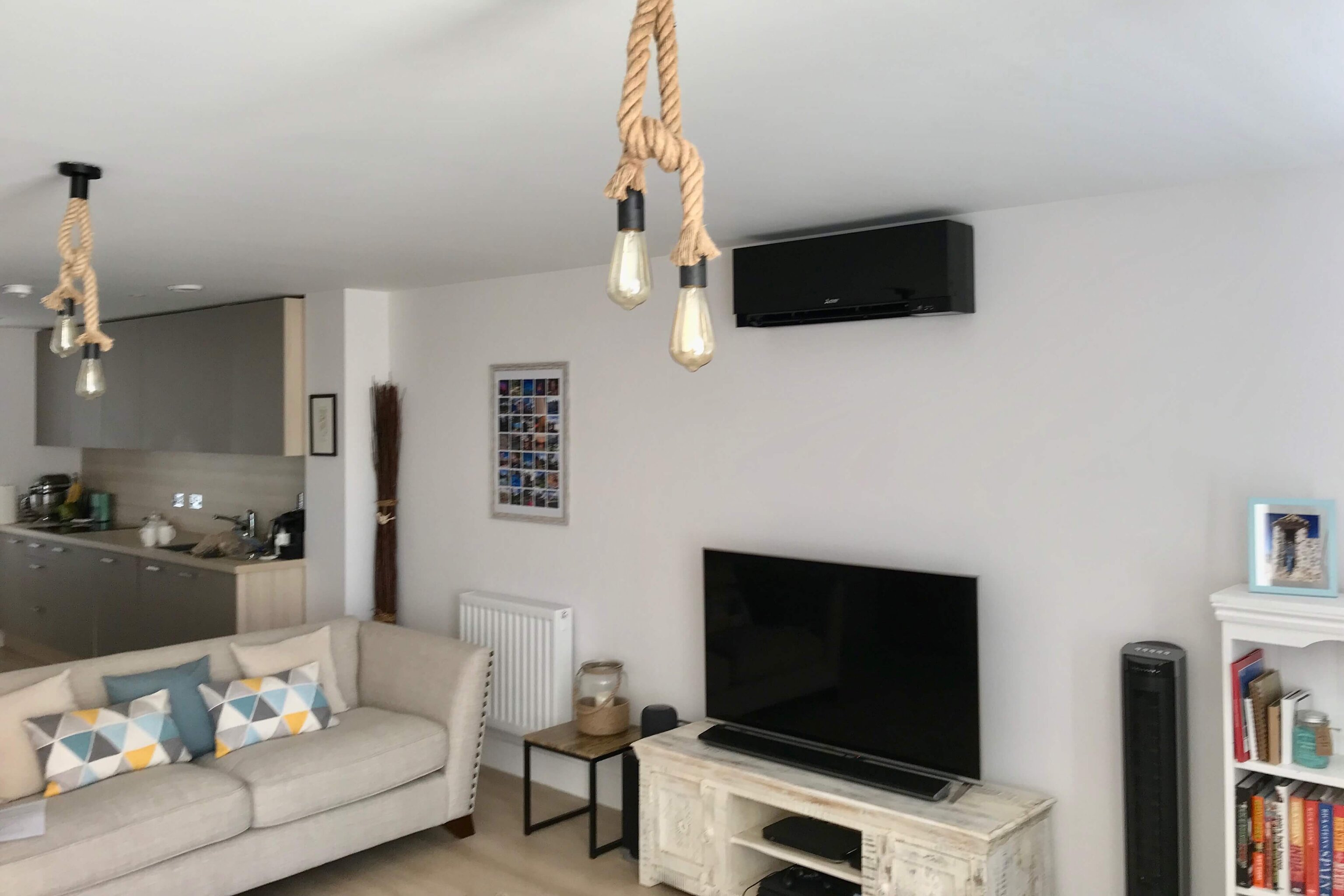 Black wall air conditioning unit in lounge kitchen