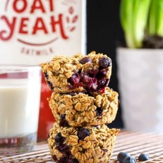 Stack of three baked oatmeal cups with oat Yeah in background