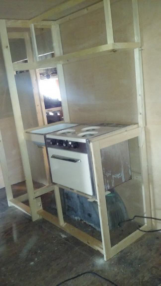 Sink/oven and upper cabinets above