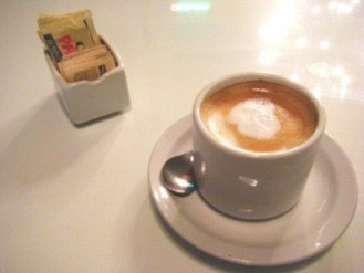 cafe con leche A cup of cafe con leche or coffee and milk as served in a cafe in Buenos Aires, Argentina