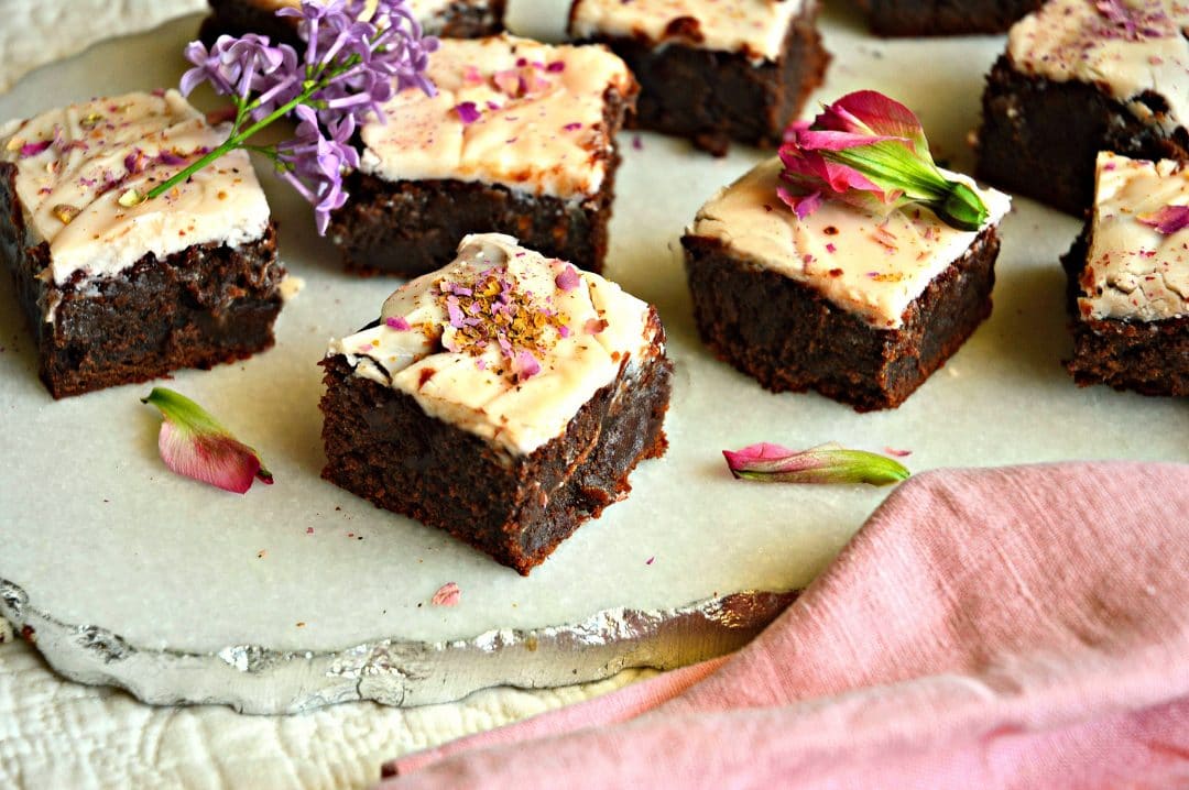 These fudgy chocolate rosewater brownies with white chocolate frosting are made from a classic recipe. The addition of rosewater makes them unique and addicting. #rosewater #brownies #baking #cookies #dessert See more at This is How I Cook.