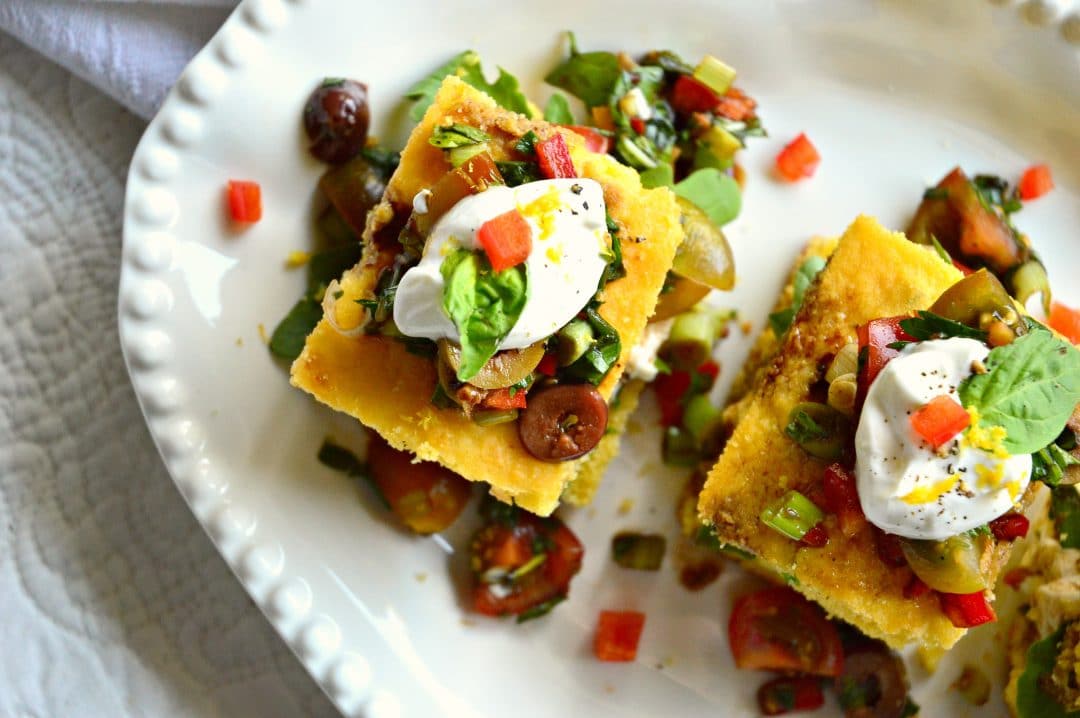 cornbread with tomato salad on white platter