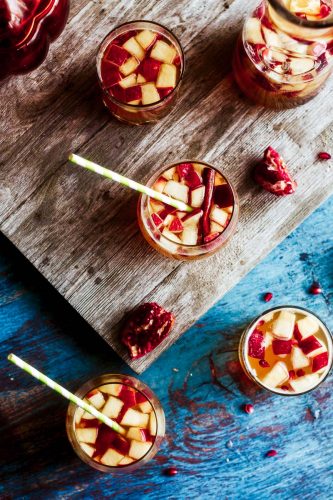 overhead shot of autumn apple cider sangria in glasses and in a carafe