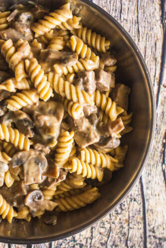 overhead shot of classic beef stroganoff in a skillet served over pasta