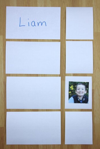 Photo of memory game using names. Four cards contain student names and 4 smaller cards contain student photos. One of each is turned over to match.