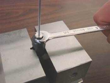 Compression fitting assembly using a pre-swage tool in a vise