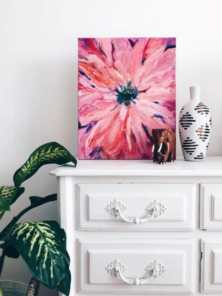 painting on top of dresser with plant beside