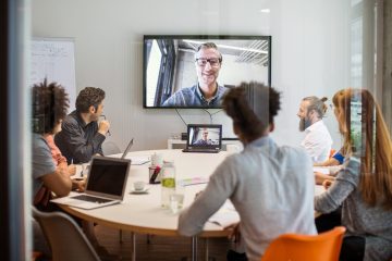 Business people having video conference meeting in board room Multi-ethnic businessmen and businesswomen having video conference meeting in board room at office