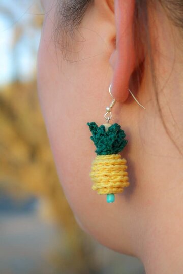 Crochet a quick and easy Crochet Pineapple Pendant or two and wear them on a necklace, bracelet, earrings or even as a zipper pull. This free crochet pattern takes very little time to accomplish with just a few basic jewelry and crochet supplies. This is a great project using only basic crochet stitches. Photo tutorial is available for any slightly tricky parts so even beginners can make this project. #forbeginners #quick #easy #crochet #freecrochetpattern #freecrochet #crochetpattern #pineapple #jewelry #crochetjewelry #crochetnecklace #crochetearrings #crochetbracelet #earrings #pineapplejewelry