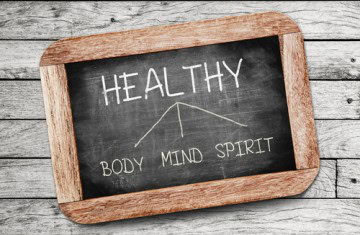 Chalkboard showing optmized health includes body, mind, spirit
