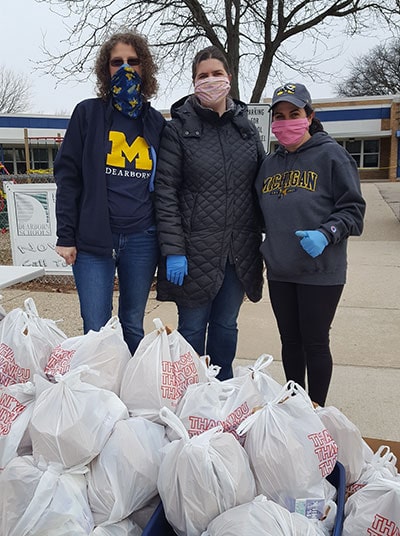 Veronica Kubitz, Julia Zamarron, and Jennie Morey (pictured from left to right) volunteered to provide students at the elementary school where they worked with access to breakfast and lunch.