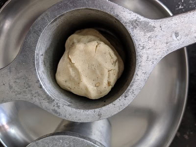 Adding the dough inside the chakli press