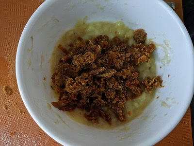 Adding jaggery to the mashed banana