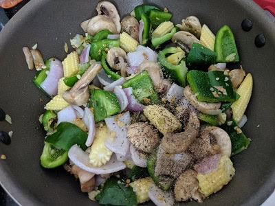 Seasoning the mixed vegetables with salt and pepper powder