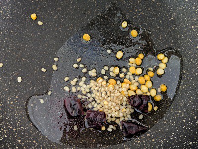 Tempering for Upma - Coconut oil, urad dal, chana dal, mustard seeds and whole red chillies
