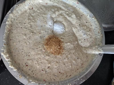 Adding salt and hing or asafoetida to the batter