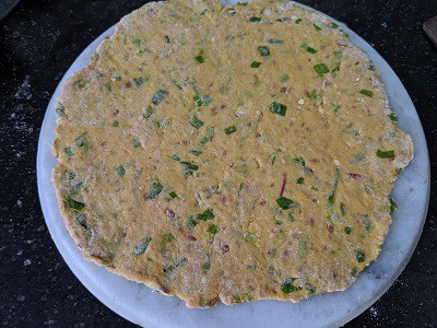 Thick spring onion paratha ready to cook on hot griddle